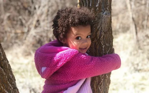 a child in a pink sweater