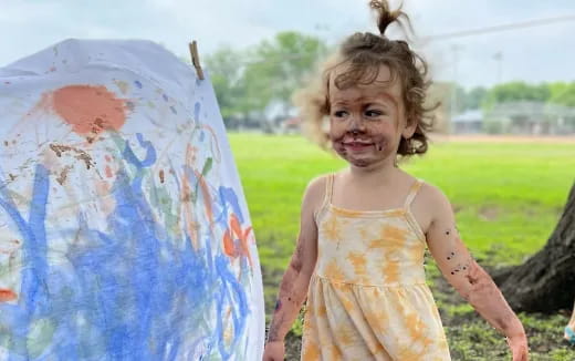 a girl holding a painting