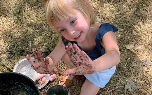 a girl holding a baby chicken