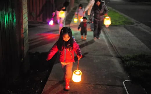 a person holding a lit candle
