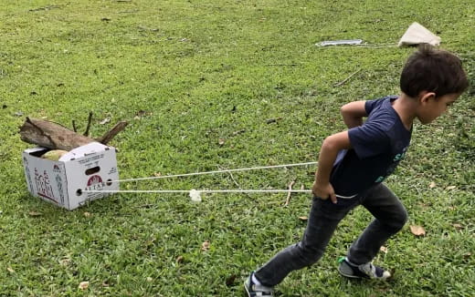 a boy playing with a box