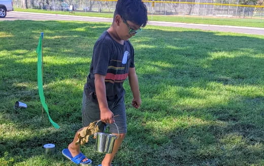 a person holding a bucket and a bucket of water