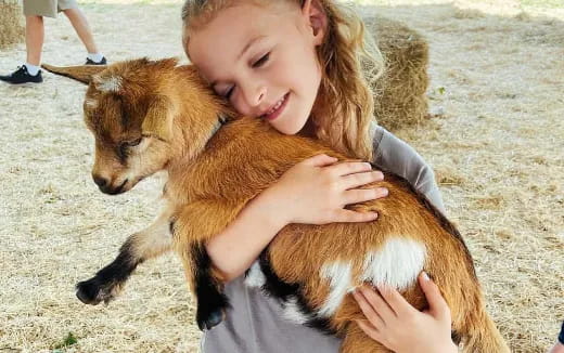 a girl holding a dog
