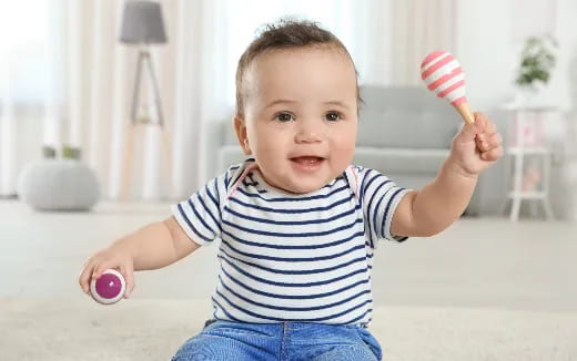 a baby holding a toy