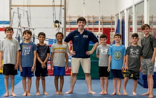 a group of boys standing on a mat