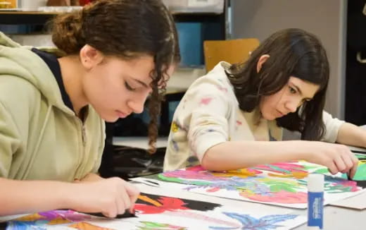 a young girl and a young boy studying