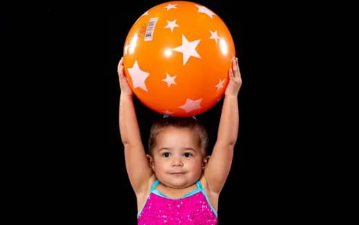 a child holding a ball