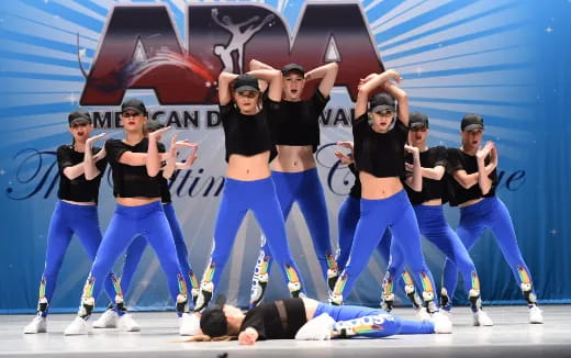 a group of people dancing on a stage