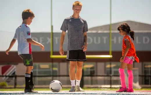 a group of kids playing football
