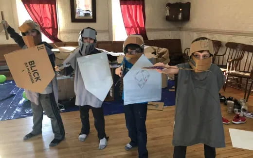 a group of people wearing masks and holding signs