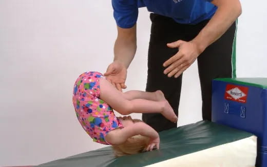 a baby being held by a person