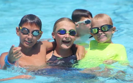 a group of kids in a pool