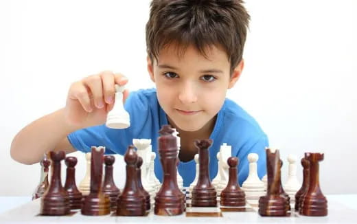 a boy playing chess