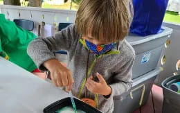 a child using a microscope