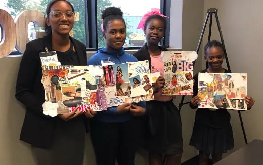 a group of people holding up books