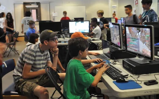 a group of people sitting at computers