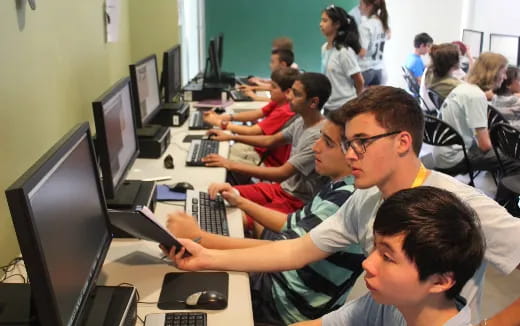 a group of people sitting at computers