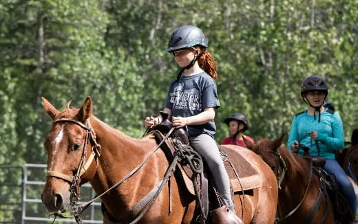 a group of people riding horses