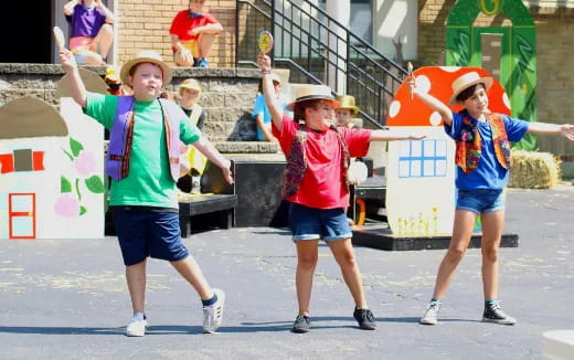 a group of kids holding up their hands