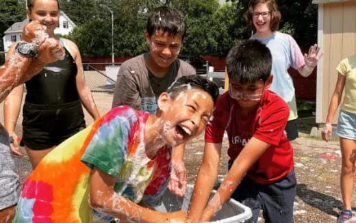 a group of people around a person in a garment