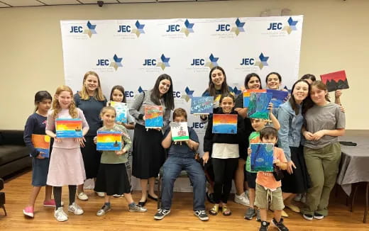 a group of children holding up colorful signs