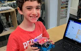 a boy holding a cupcake