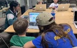 a group of people using laptops