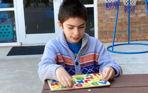 a boy sitting at a table