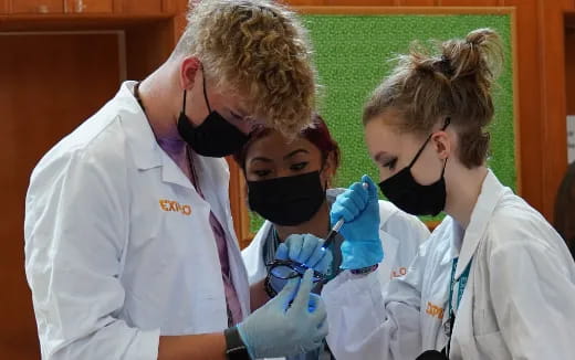 a group of people in lab coats