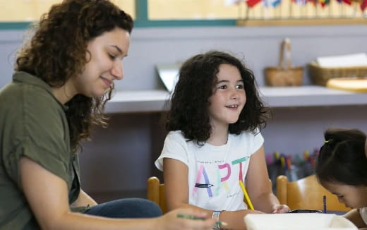 a person and a child sitting at a table