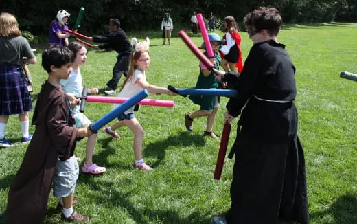 a group of children playing with bows and arrows