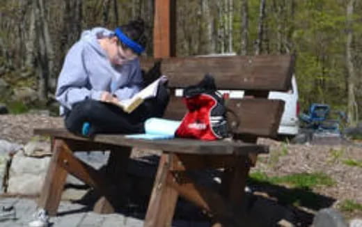 a person sitting at a table outside