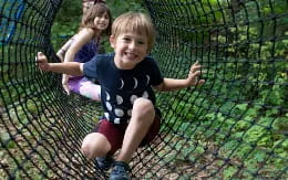 a boy and girl in a cage