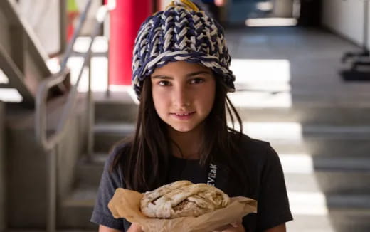 a person holding a sandwich