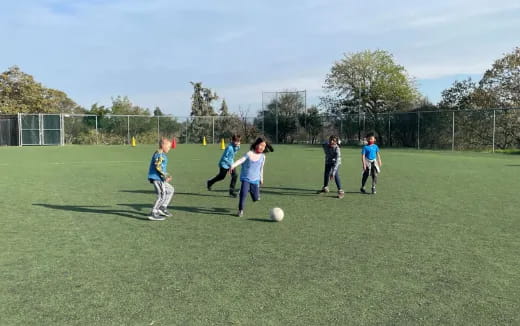 a group of kids playing football