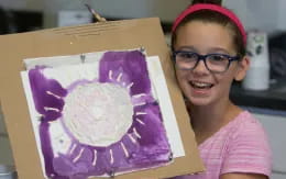 a girl holding a box