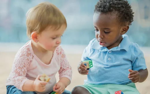a couple of children sitting on the floor