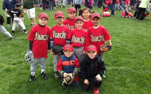 a group of kids wearing baseball uniforms