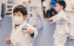 a boy wearing a white uniform