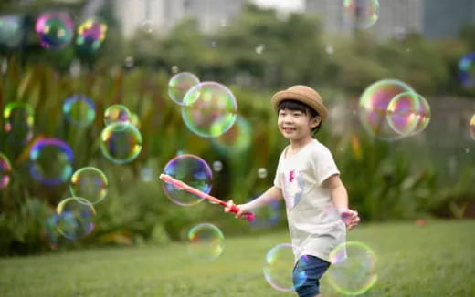 a child running with bubbles