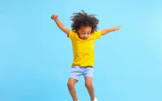 a young girl jumping in the air