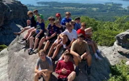 a group of people sitting on a rock