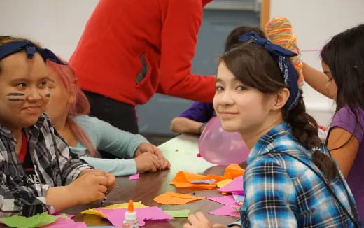 a group of children sitting at a table
