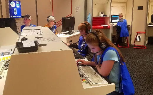 a group of kids working on a computer