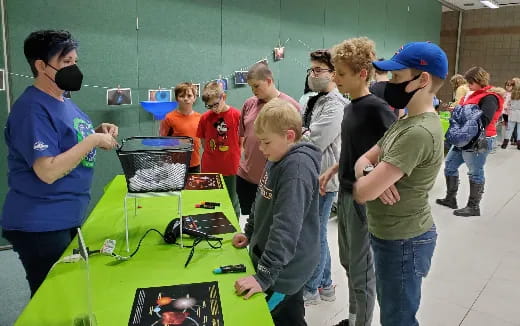 a group of people looking at a computer