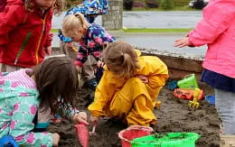 a group of children playing in the mud