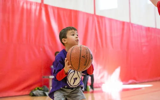 a boy holding a basketball