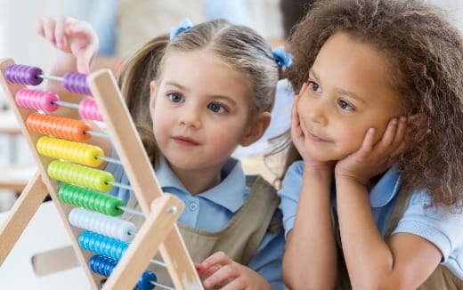a couple of young girls sit near each other