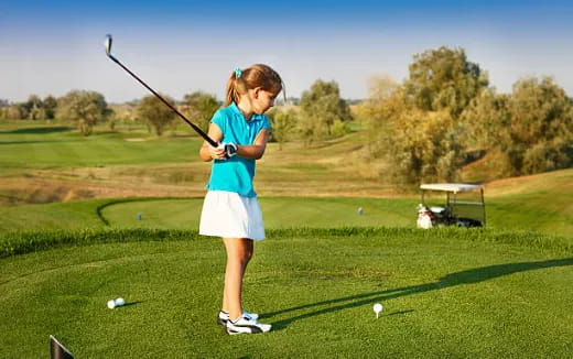 a girl playing golf