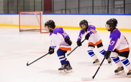 a group of people playing hockey